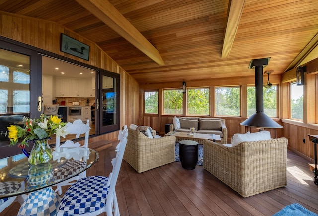 sunroom / solarium with wood ceiling, a healthy amount of sunlight, and vaulted ceiling with beams