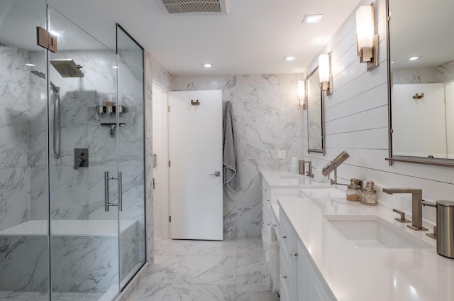 full bathroom featuring marble finish floor, visible vents, a sink, and a marble finish shower