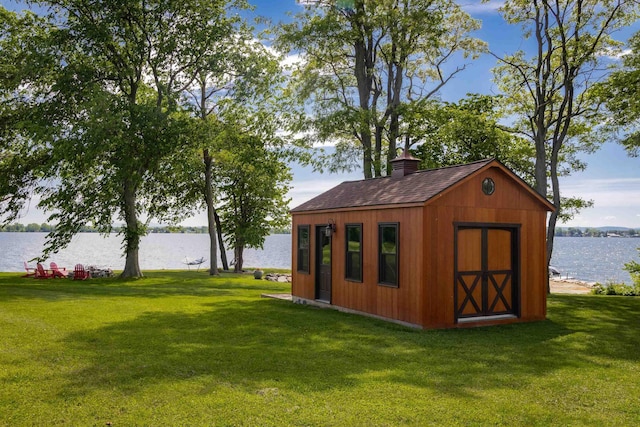 view of outdoor structure featuring an outbuilding and a water view