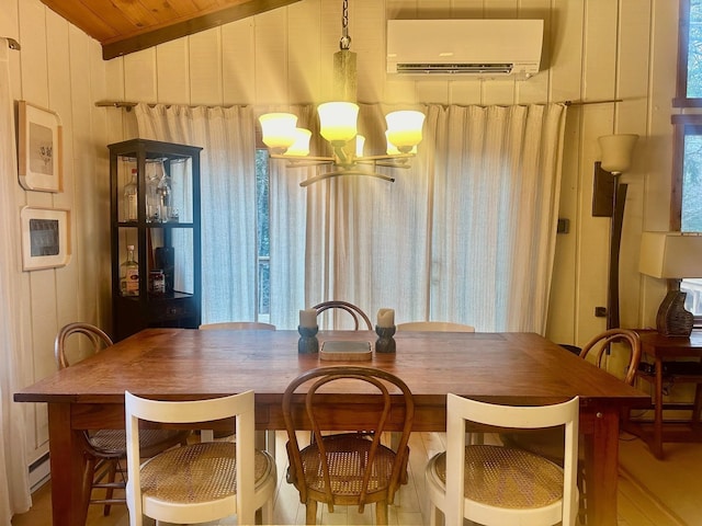 dining room featuring vaulted ceiling, a wall mounted air conditioner, an inviting chandelier, and wooden walls