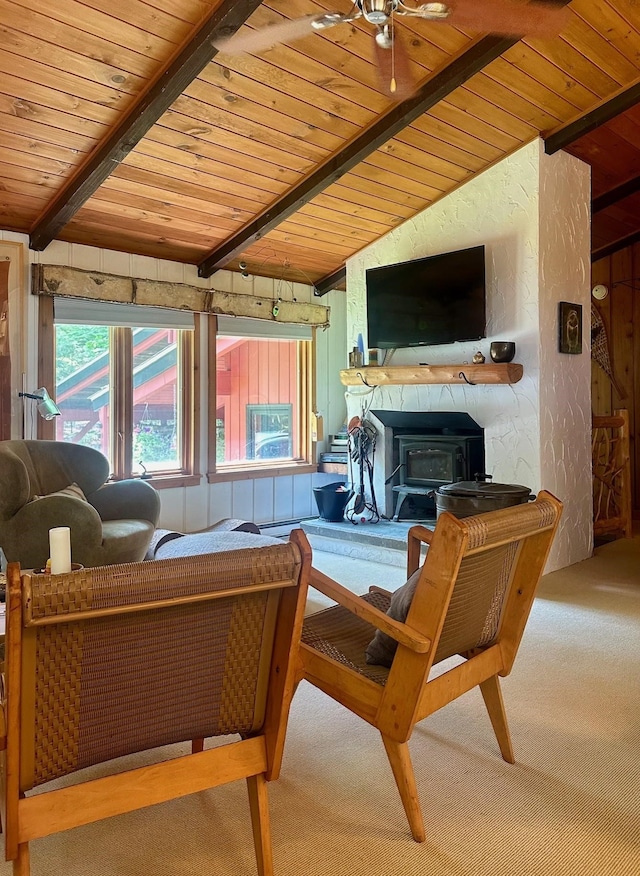 living area with a textured wall, wooden ceiling, carpet flooring, and vaulted ceiling with beams