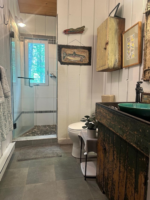 full bath featuring toilet, a shower stall, a baseboard heating unit, and vanity