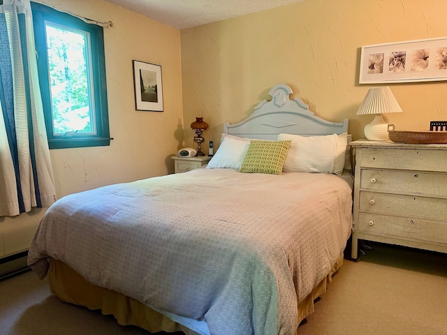 carpeted bedroom featuring baseboard heating