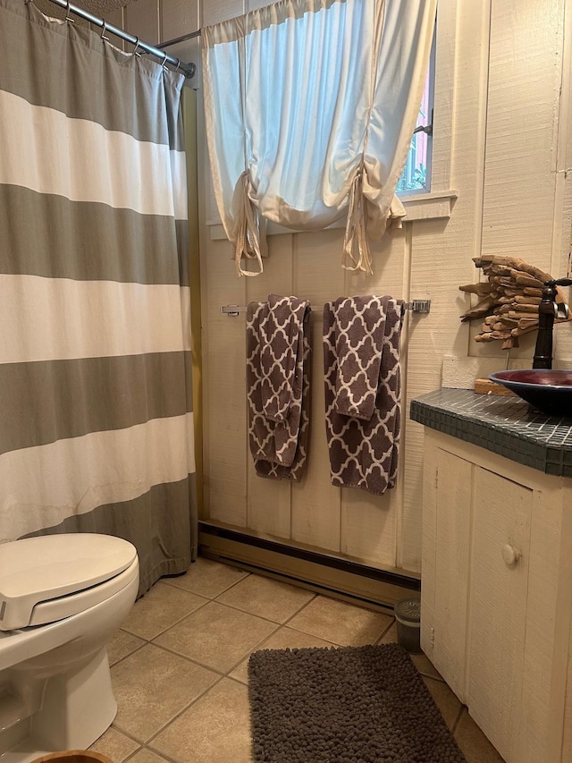 full bathroom with curtained shower, a baseboard radiator, toilet, vanity, and tile patterned floors