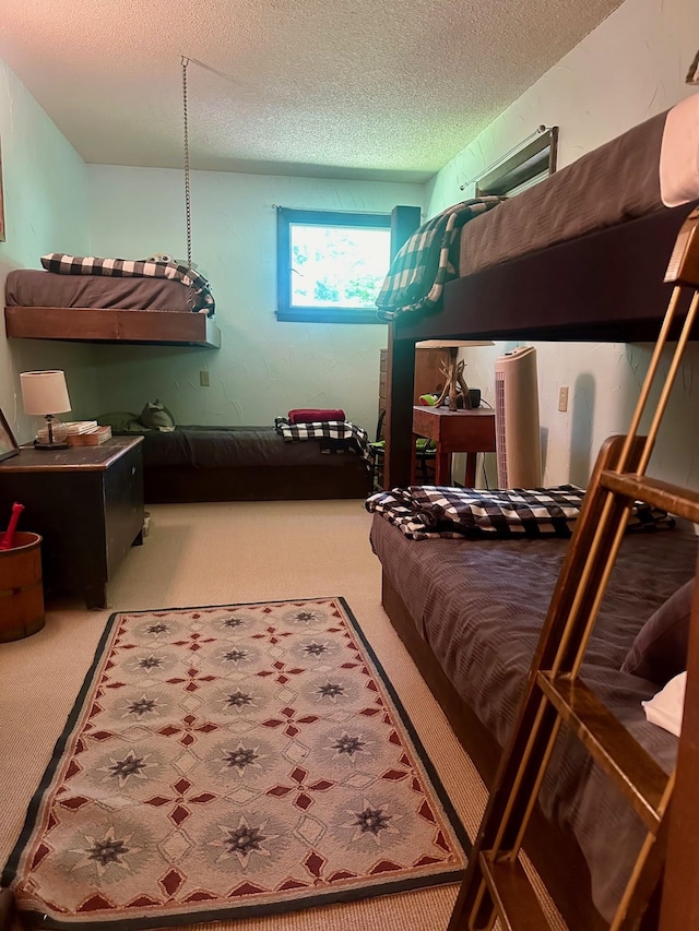 bedroom featuring a textured ceiling and carpet