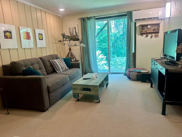 living area with a textured ceiling, wooden walls, carpet floors, ornamental molding, and a wall mounted AC