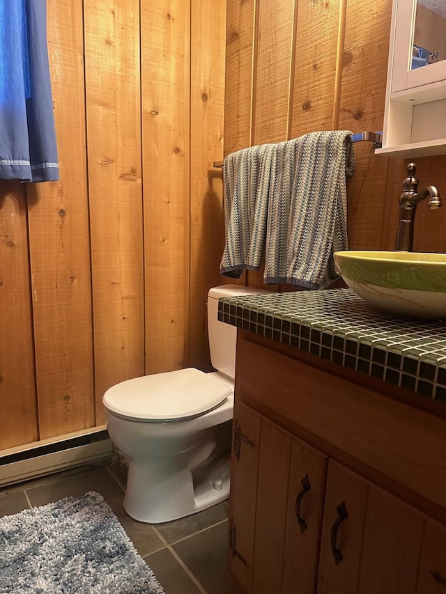 bathroom with toilet, tile patterned flooring, and vanity