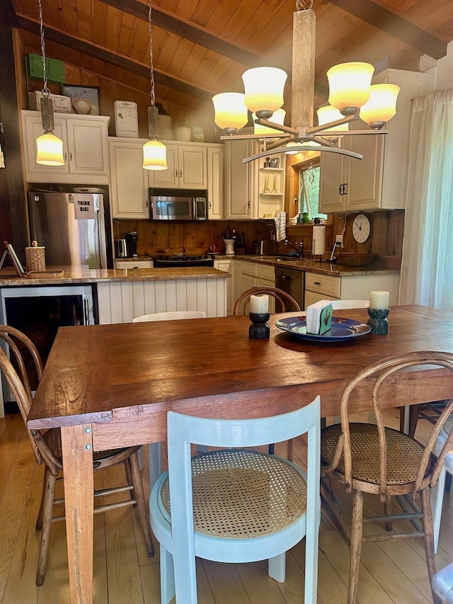 dining space featuring vaulted ceiling with beams and wooden ceiling