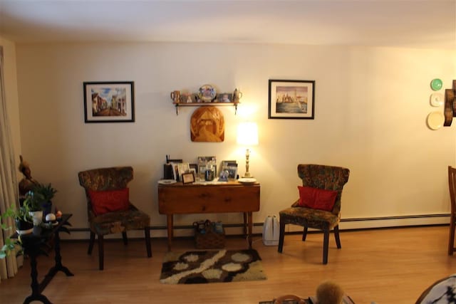 living area with a baseboard radiator and wood finished floors