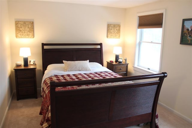 carpeted bedroom featuring baseboards