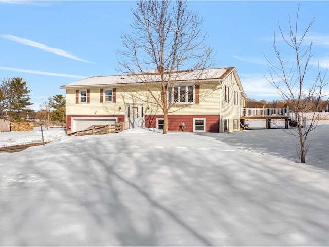 view of front facade with a deck and an attached garage