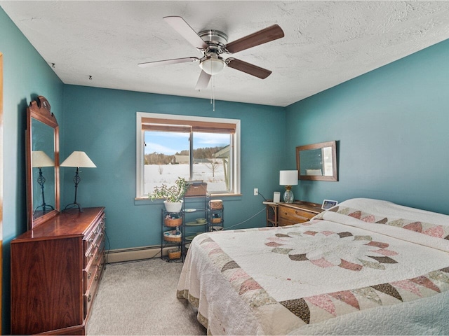 bedroom with light carpet, baseboards, baseboard heating, and a textured ceiling