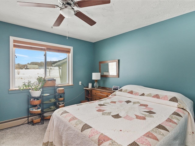 bedroom with a ceiling fan, carpet flooring, and a textured ceiling