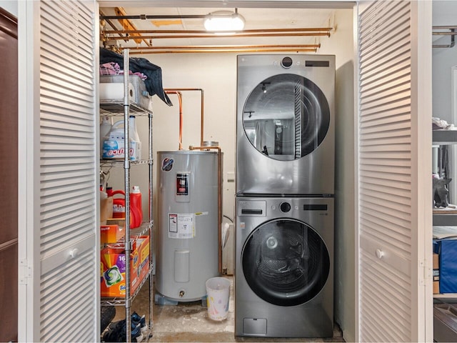 laundry area featuring laundry area, stacked washer / drying machine, and electric water heater