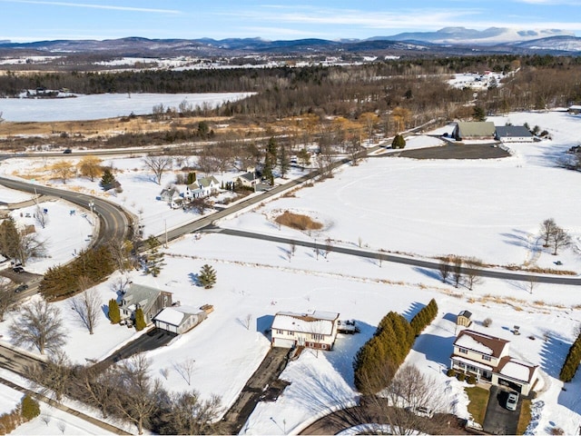 snowy aerial view with a mountain view