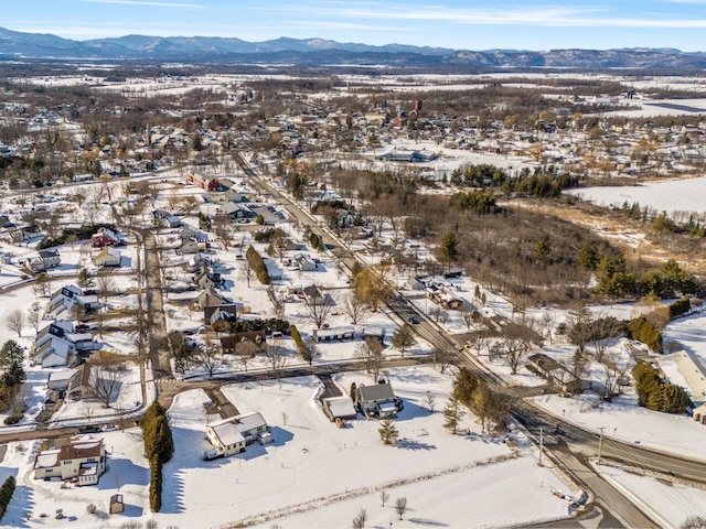 snowy aerial view with a mountain view