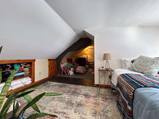 bedroom with vaulted ceiling and baseboards