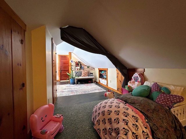 bedroom featuring lofted ceiling and carpet flooring