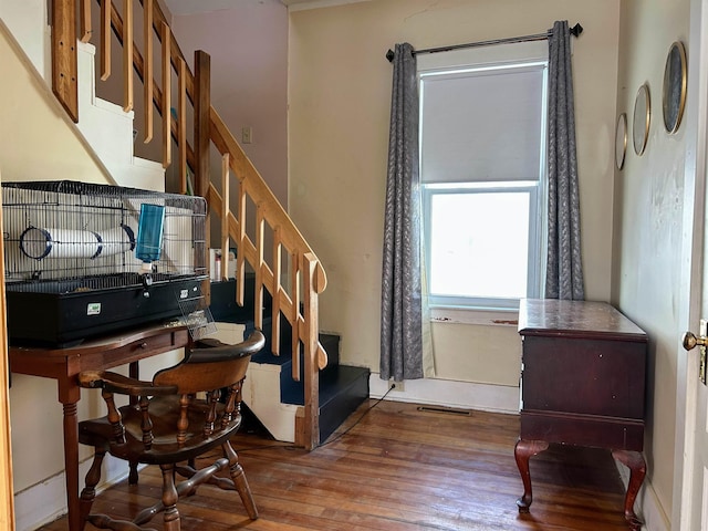 stairs with visible vents and wood finished floors