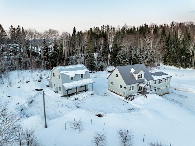 snowy aerial view with a view of trees