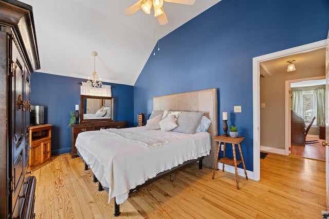 bedroom featuring high vaulted ceiling, light wood-type flooring, a notable chandelier, and baseboards