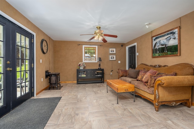 living room featuring french doors, a ceiling fan, and baseboards