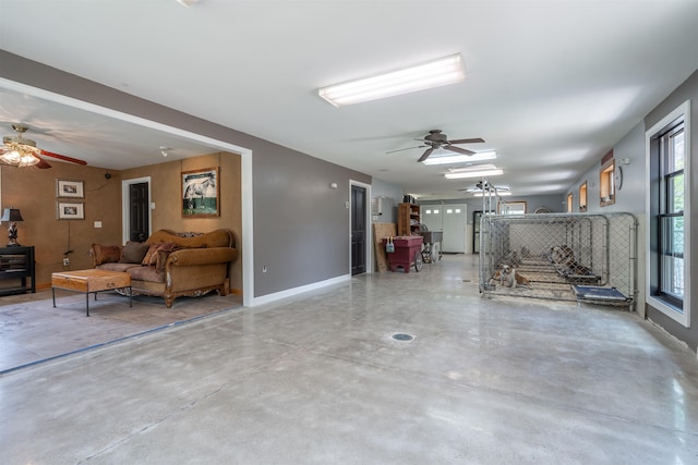 interior space featuring ceiling fan and baseboards