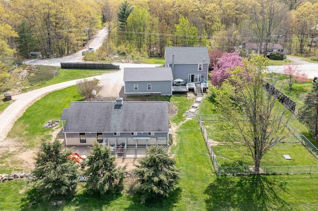 birds eye view of property with a view of trees