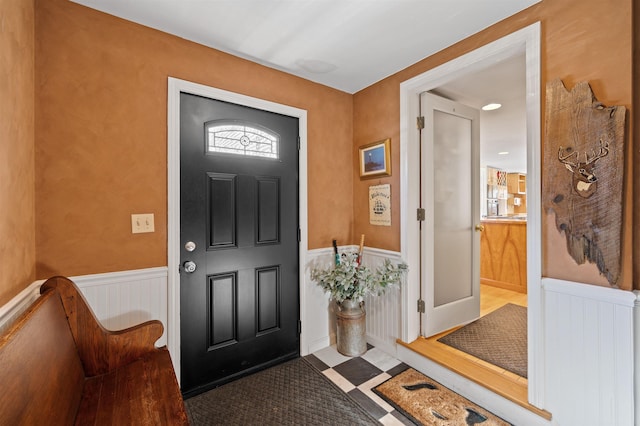 entryway featuring tile patterned floors and wainscoting