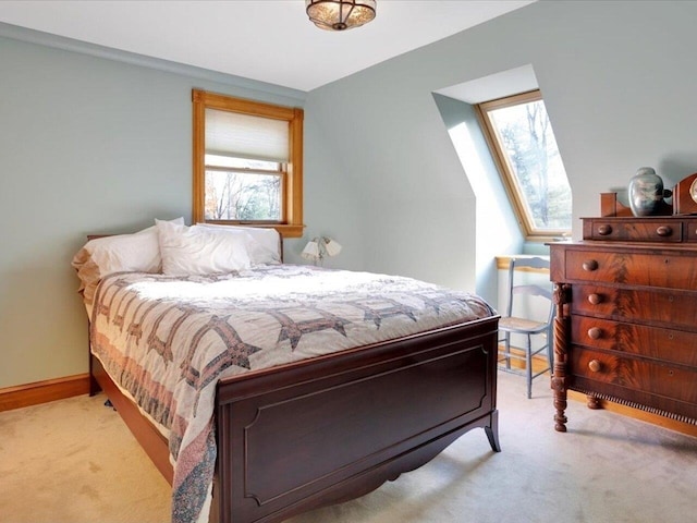 bedroom with a skylight, carpet flooring, and baseboards