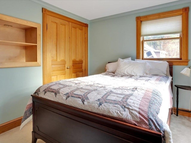 bedroom with carpet, crown molding, and baseboards