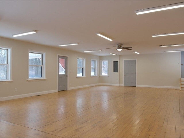 unfurnished room with light wood-style floors, baseboards, and a ceiling fan