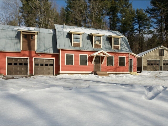 view of front of home featuring a garage, a standing seam roof, and metal roof