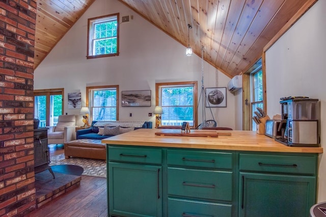 kitchen with butcher block countertops, open floor plan, green cabinetry, and a wall mounted AC