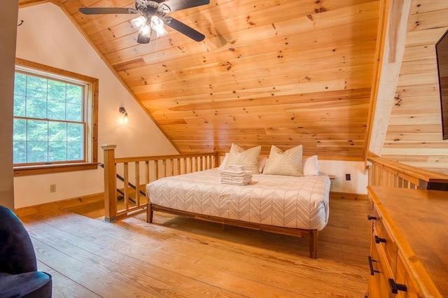 bedroom featuring wood ceiling, light wood-style flooring, baseboards, and vaulted ceiling