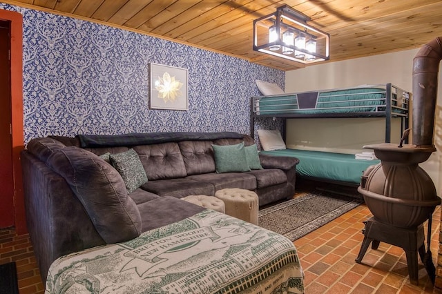 bedroom with brick floor, wood ceiling, and wallpapered walls