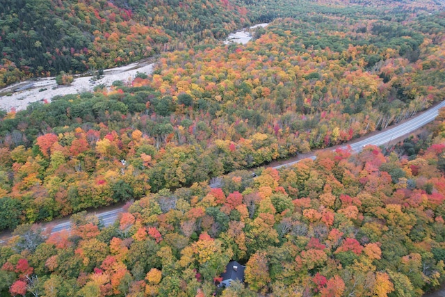 drone / aerial view featuring a wooded view