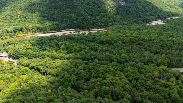 birds eye view of property featuring a view of trees