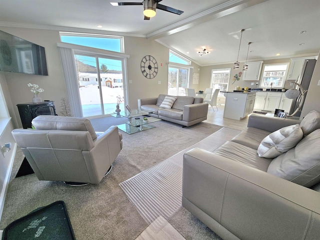 living room with vaulted ceiling, a ceiling fan, and crown molding