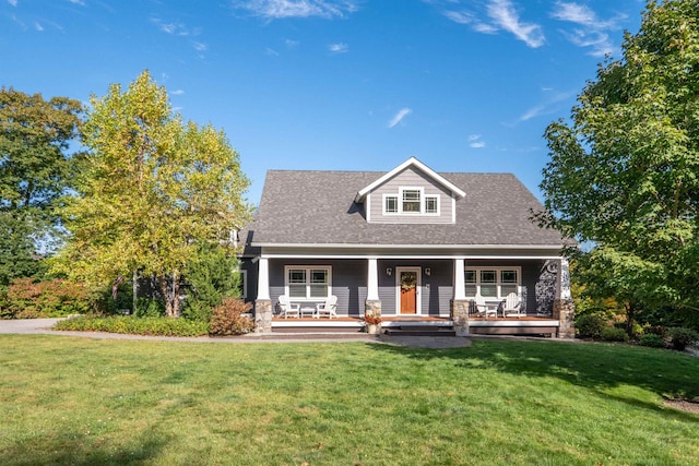 view of front facade featuring covered porch and a front lawn