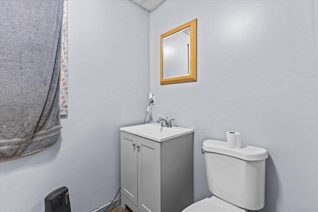 half bathroom with vanity and toilet