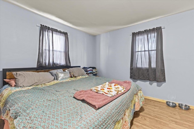 bedroom with wood finished floors and baseboards