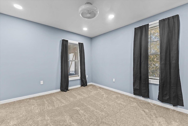 spare room with carpet floors, recessed lighting, and baseboards