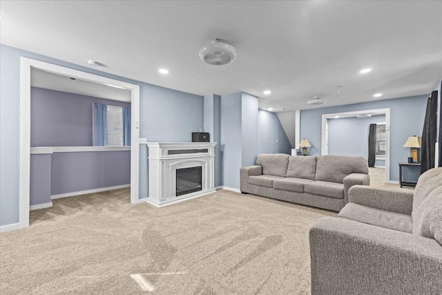 living room featuring carpet floors, recessed lighting, a glass covered fireplace, and baseboards