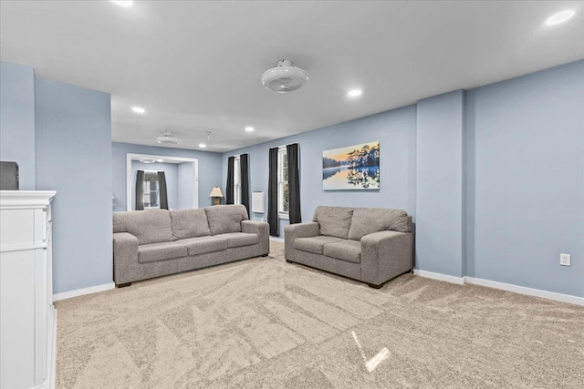 carpeted living room with recessed lighting and baseboards