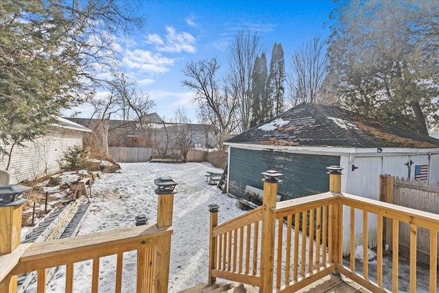 yard layered in snow featuring fence