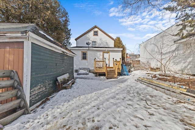 snow covered house featuring a deck