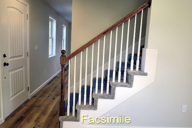 stairway with wood finished floors and baseboards