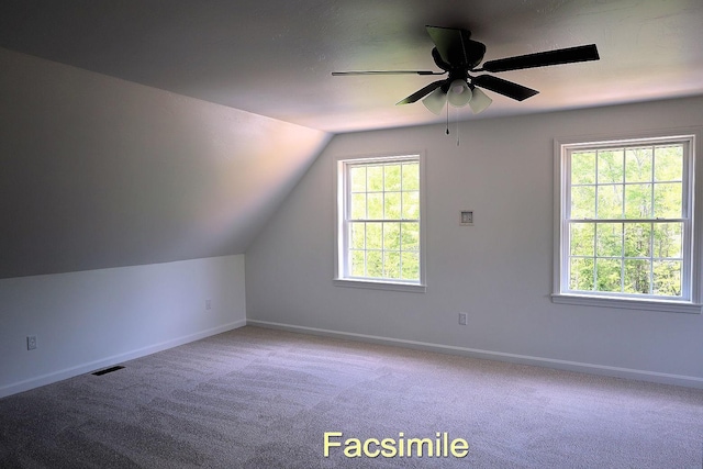 additional living space featuring carpet, visible vents, lofted ceiling, and baseboards