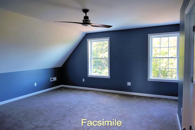 additional living space with lofted ceiling, carpet floors, a ceiling fan, and baseboards